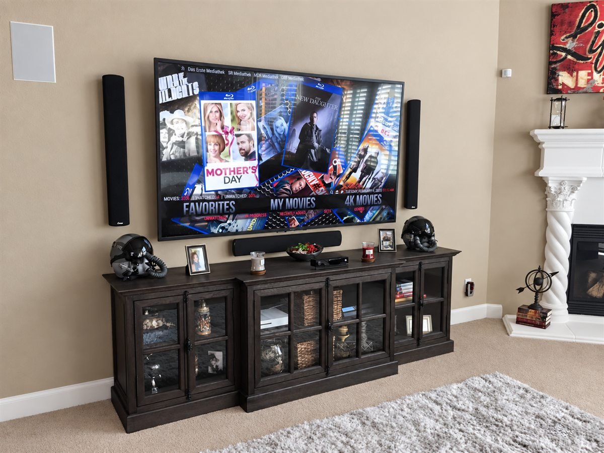 Media room with wall-mounted television, speakers and storage console